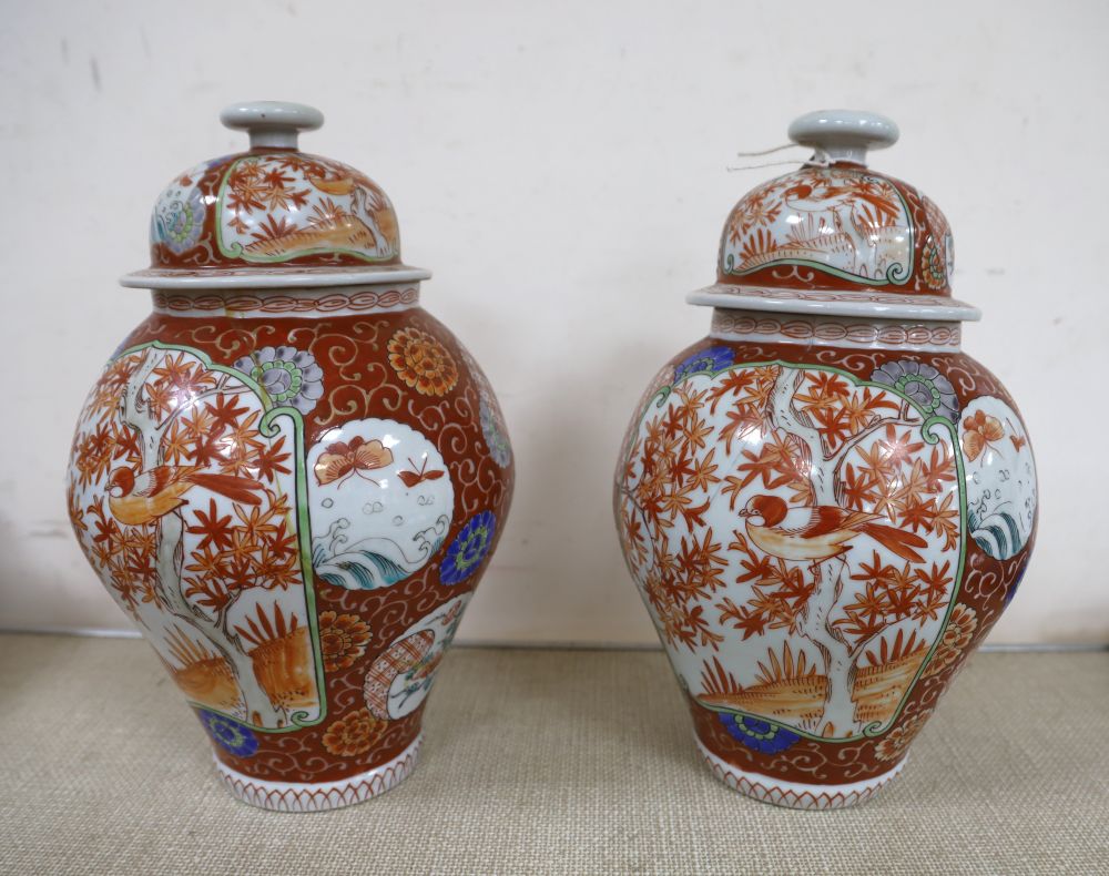 A near pair of Japanese porcelain lidded vases